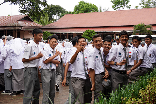 カメラに向かって笑顔を向ける国立高校の生徒たちの写真