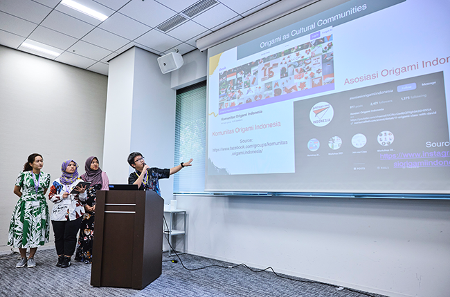 Four participants giving presentations in front of a screen projected at the front of the classroom
