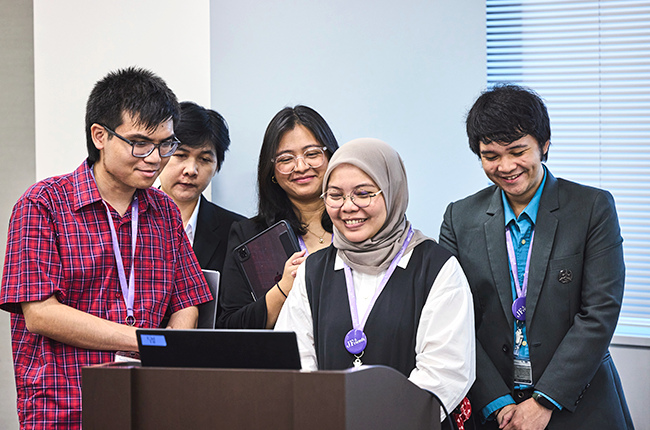 Close-up of five participants around a podium
