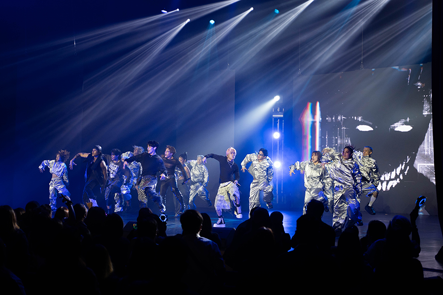 A large group of men are dancing.