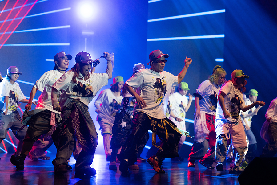 A large group of men and women are dancing