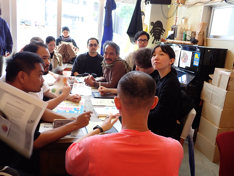 Ten people are sitting and having a discussion.